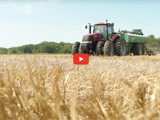 image of cornfield with red tractor and blue skys and red video play button
