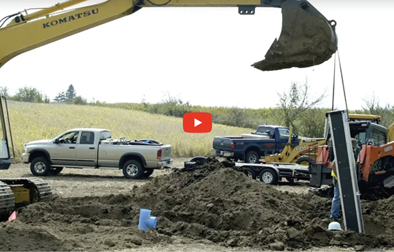 Image of a crane moving dirt with a pile of dirt