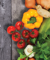 a variety of colorful vegetables laying on a wood table